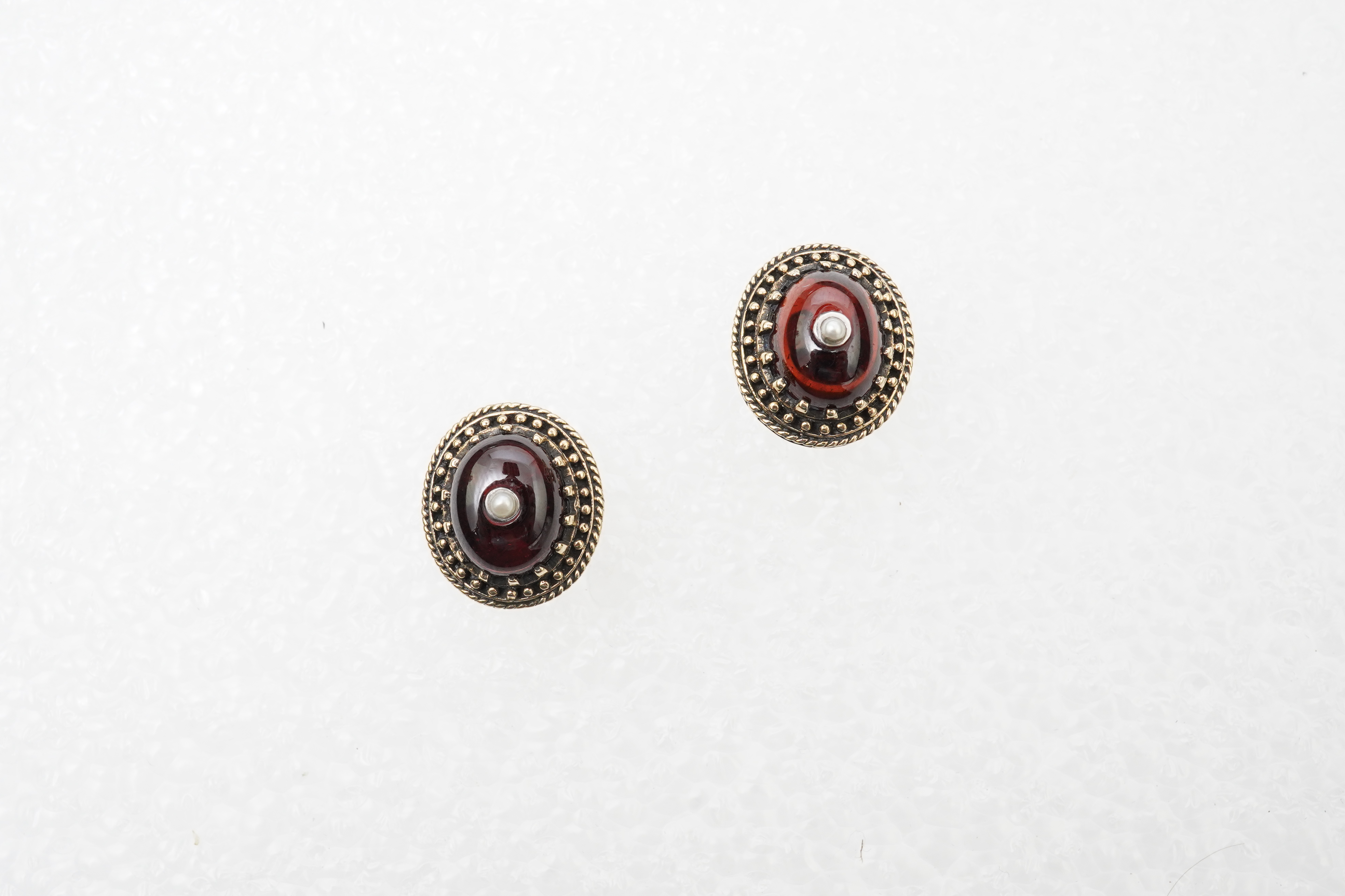A modern 18ct gold and multi gem set cluster ring, size P, together with two 9ct rings including moss agate and a pair of 9ct gold and seed pearl set cabochon garnet ear studs.